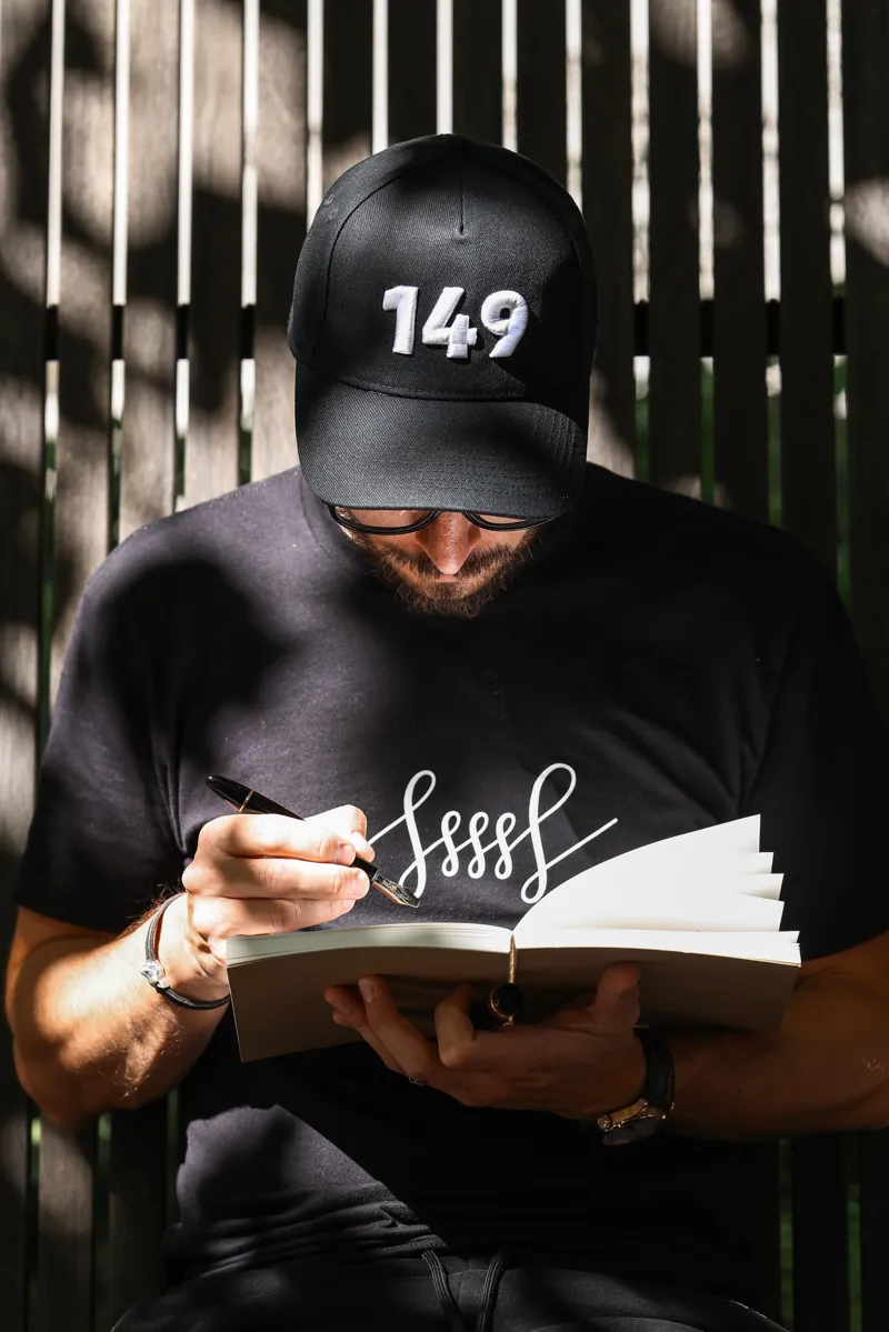 Filip writing in his notebook