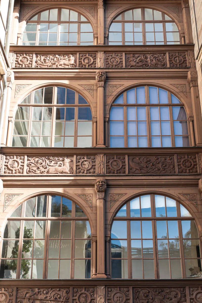 Carved architectural details around rows of windows in the castle.