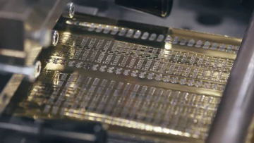 A close-up of Faber-Castell lettering and jousting-knights logos on metallic stamping foil.