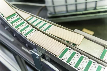 Grooved wooden slats moving along the Faber-Castell production line.