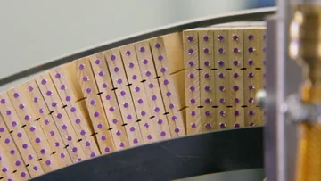 Cross-sections of joined wooden slats with purple pencil cores at Faber-Castell.