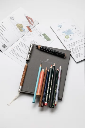 An overhead view of pencils, a Graf von Faber-Castell notebook and leaflets from our visit to Stein.