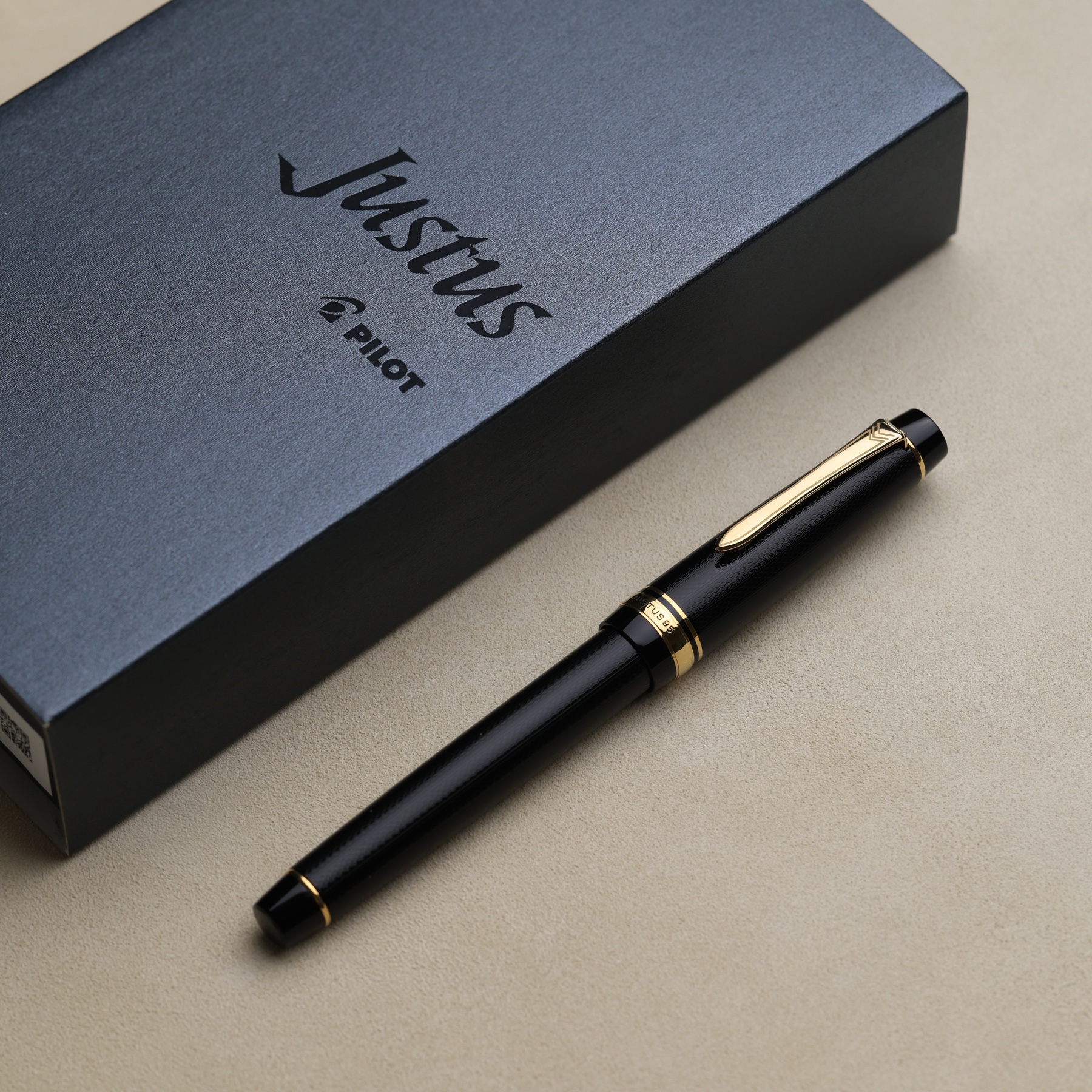 Black and gold Pilot Justus 95 fountain pen in a writing desk arrangement