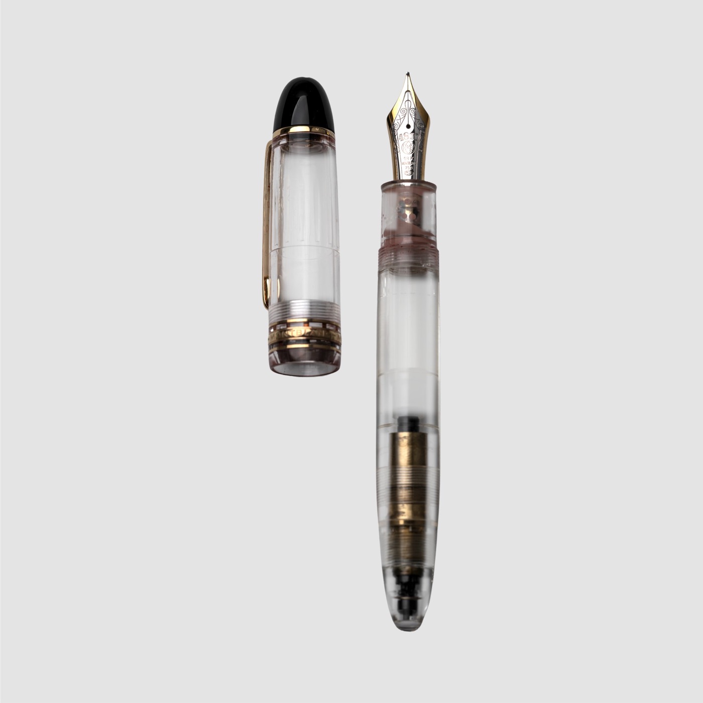Montblanc Meisterstück 149 Demonstrator fountain pen and transparent cap, with a two-tone 18K gold nib, gold-plated fittings and visible piston-filling mechanism