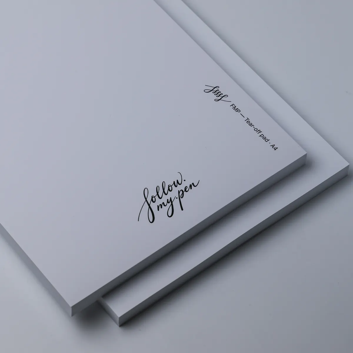 Angled close-up of an FMP Tear-Off Pad A4 cover, with the Follow My Pen logo and A4 label