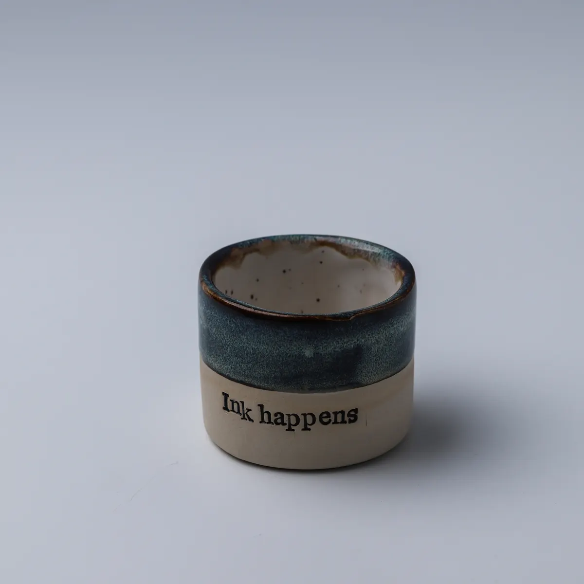 Ink Happens ceramic mug viewed from above, showing its speckled glazed interior