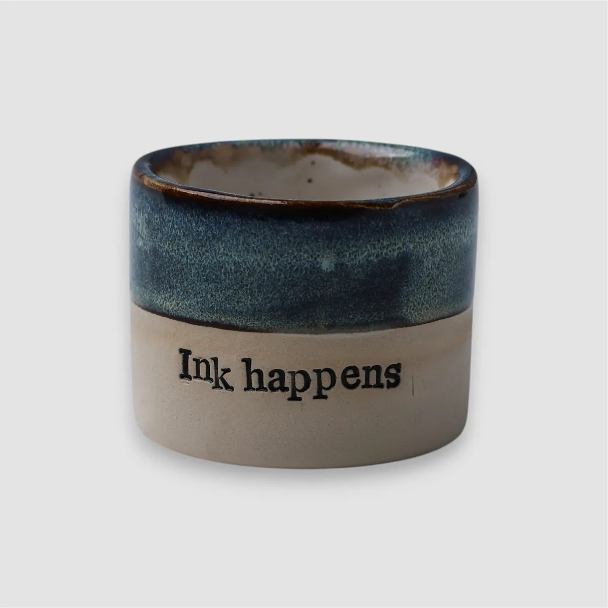 Handmade Ink Happens ceramic mug by KERANIKA with blue glaze and a natural clay base
