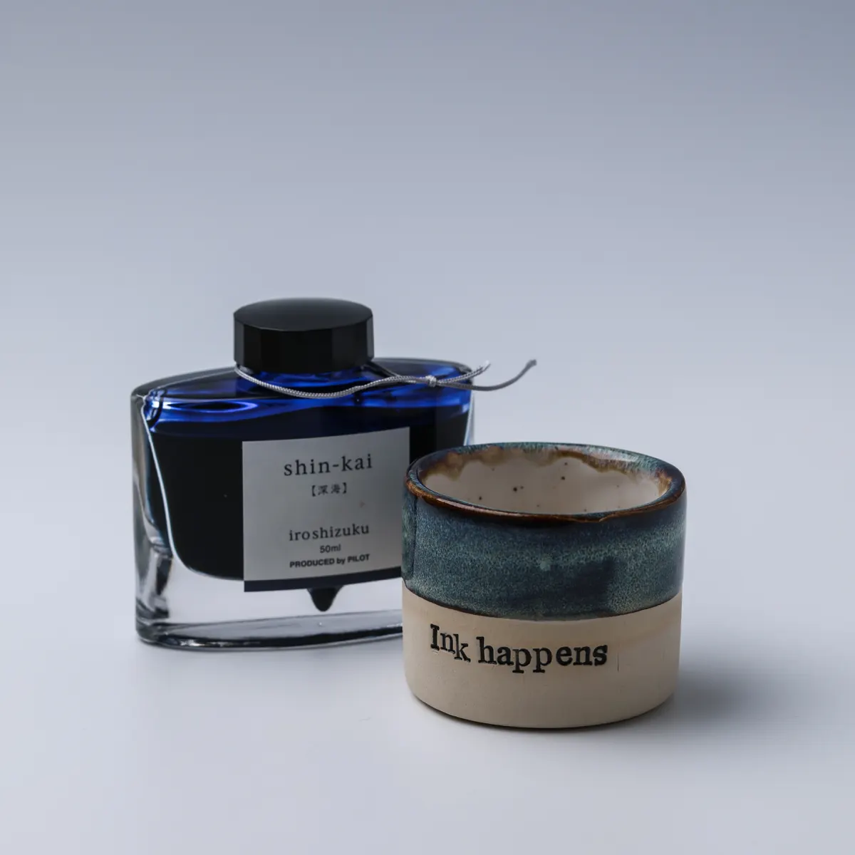Ink Happens mug beside a bottle of Pilot Iroshizuku Shin-kai fountain pen ink